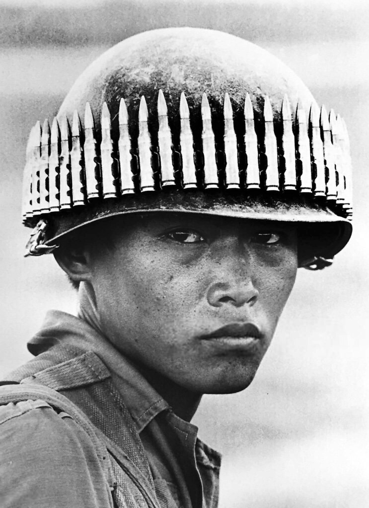 Vietnam Soldier with bullet-studded helmet