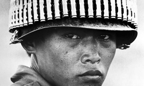 Vietnam Soldier with bullet-studded helmet