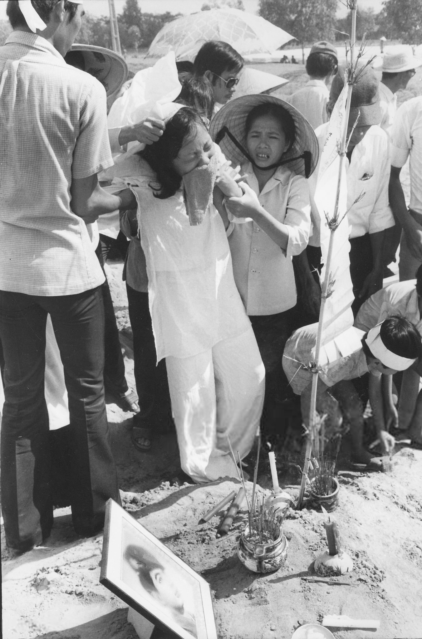 Vietnamese widow grieves for her recently slain military husband at graveside north of Saigon days before the city fell to the North Vietnamese in April 1975