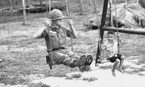 Vietnam War 1966 - U.S. Soldier and Vietnamese Child on Swingset (July 26, 1966)