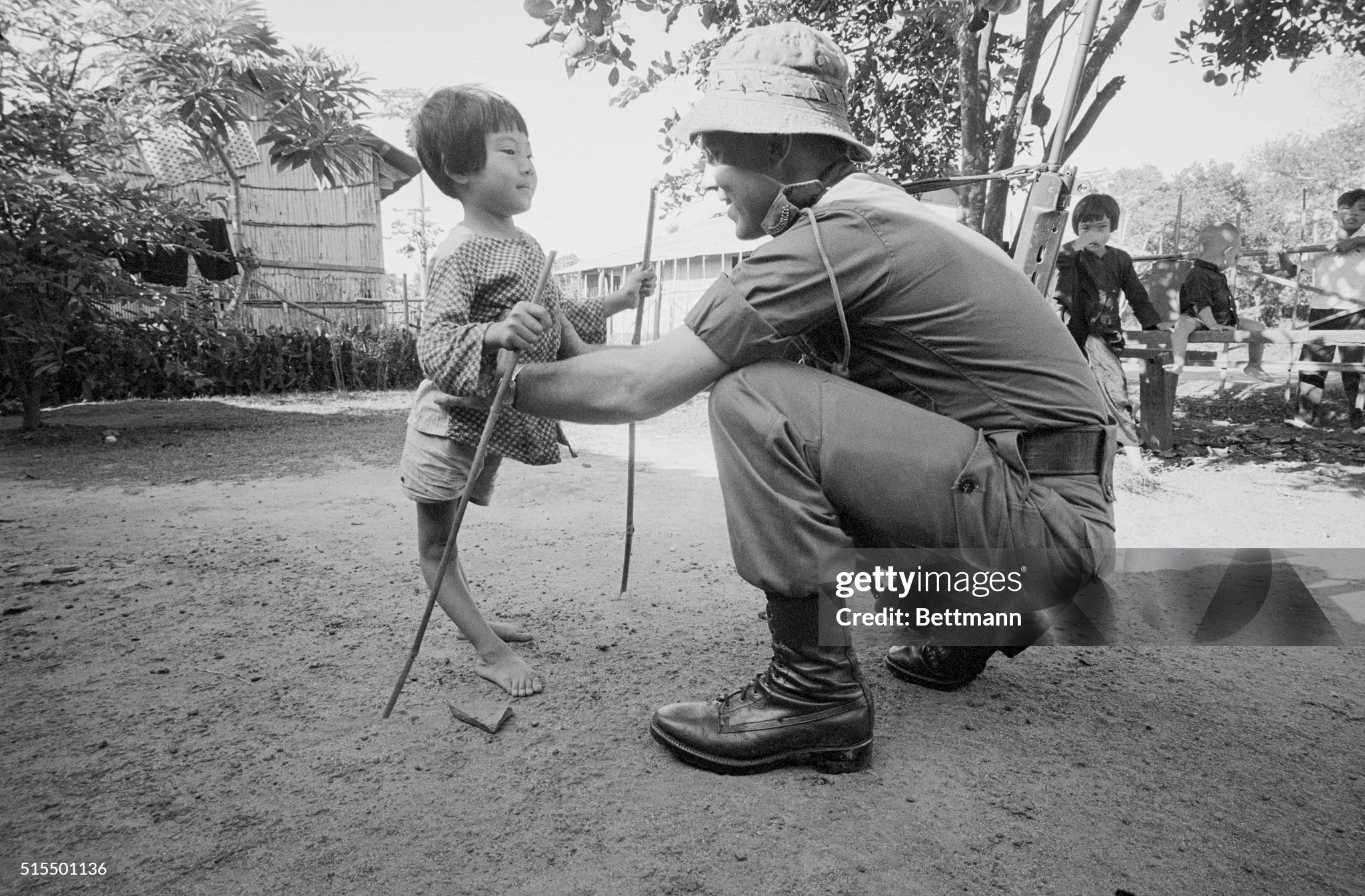 Aussie Help for Crippled Girl. Saigon, South Vietnam: Her legs twisted and deformed, a tiny Vietnamese girl struggles into the arms of an Australian soldier during the recent Operation Haymen. Under the care of Australian medical teams, [. . .] little girl will soon be walking without the aid of bamboo crutches. November 12, 1966.