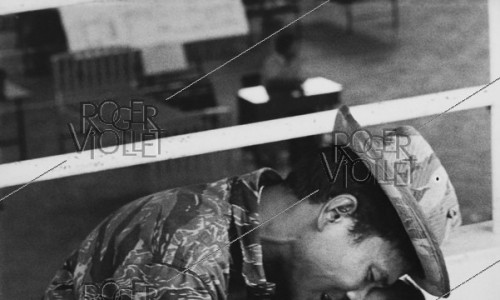 Vietnam War. Wounded child at the hospital with his father, he died a few days later. Saigon, 1975
