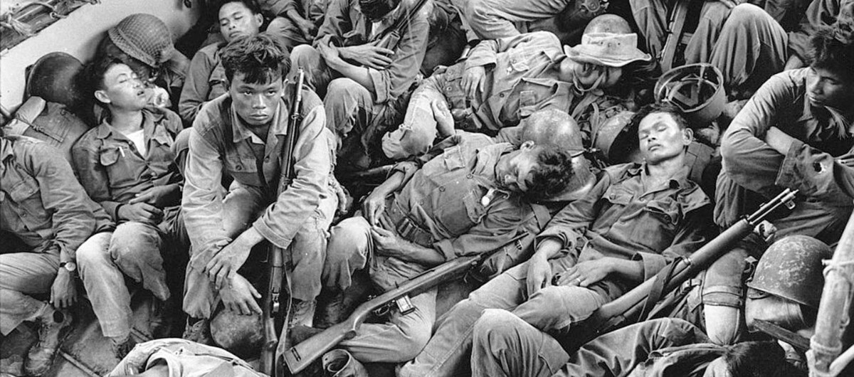 South Vietnamese government troops from the 2nd Battalion of the 36th Infantry sleep in a U.S. Navy troop carrier on their way back to the Provincial capital of Ca Mau, Vietnam. Photo by Horst Faas/AP