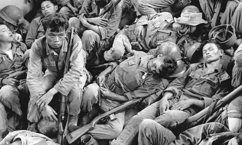 South Vietnamese government troops from the 2nd Battalion of the 36th Infantry sleep in a U.S. Navy troop carrier on their way back to the Provincial capital of Ca Mau, Vietnam. Photo by Horst Faas/AP