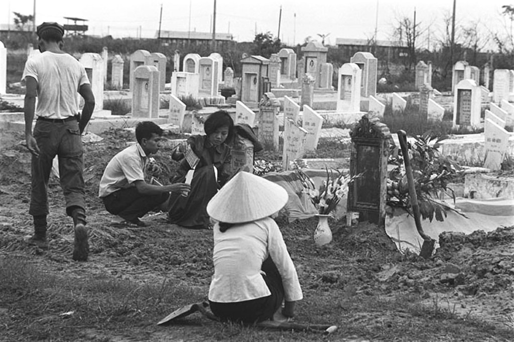 Vietnamese women at burial of Vietnamese officer killed during fighting in Saigon. June 1968 - Douglas Pike Photograph Collection
