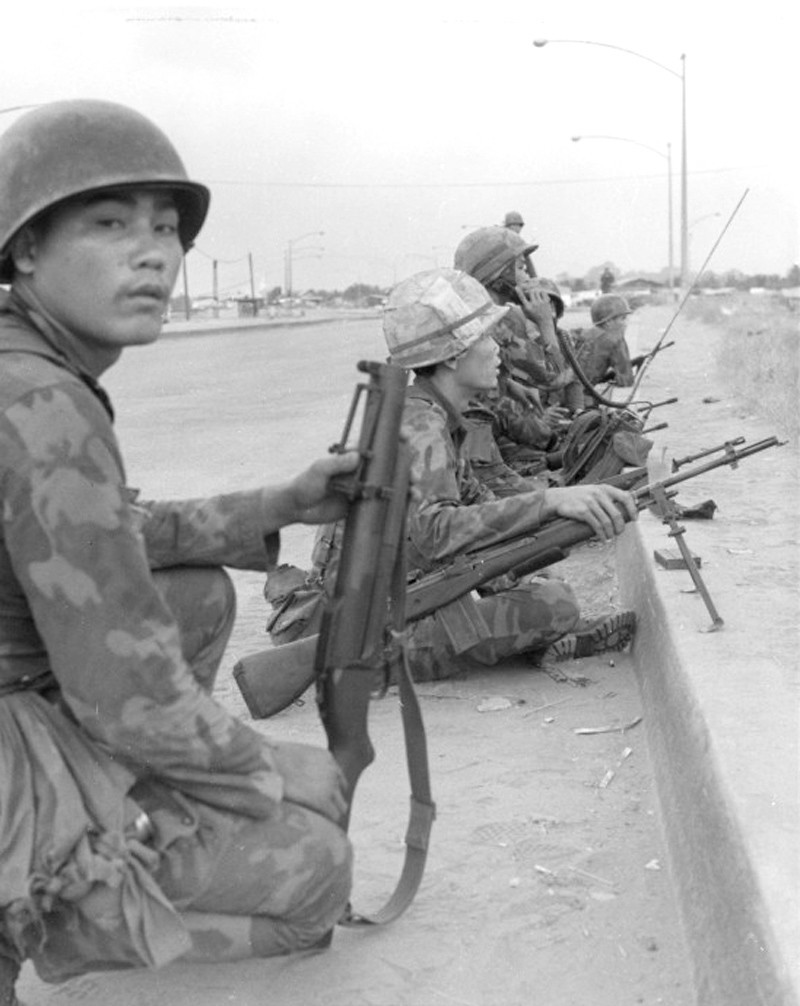 A squad of South Vietnamese soldiers of Co C, 30th ranger Bn, are on the alert for Viet Cong snipers just across Newport Bridge Mini-Tet - Douglas Pike Collection - Vietnam Center and Archive
