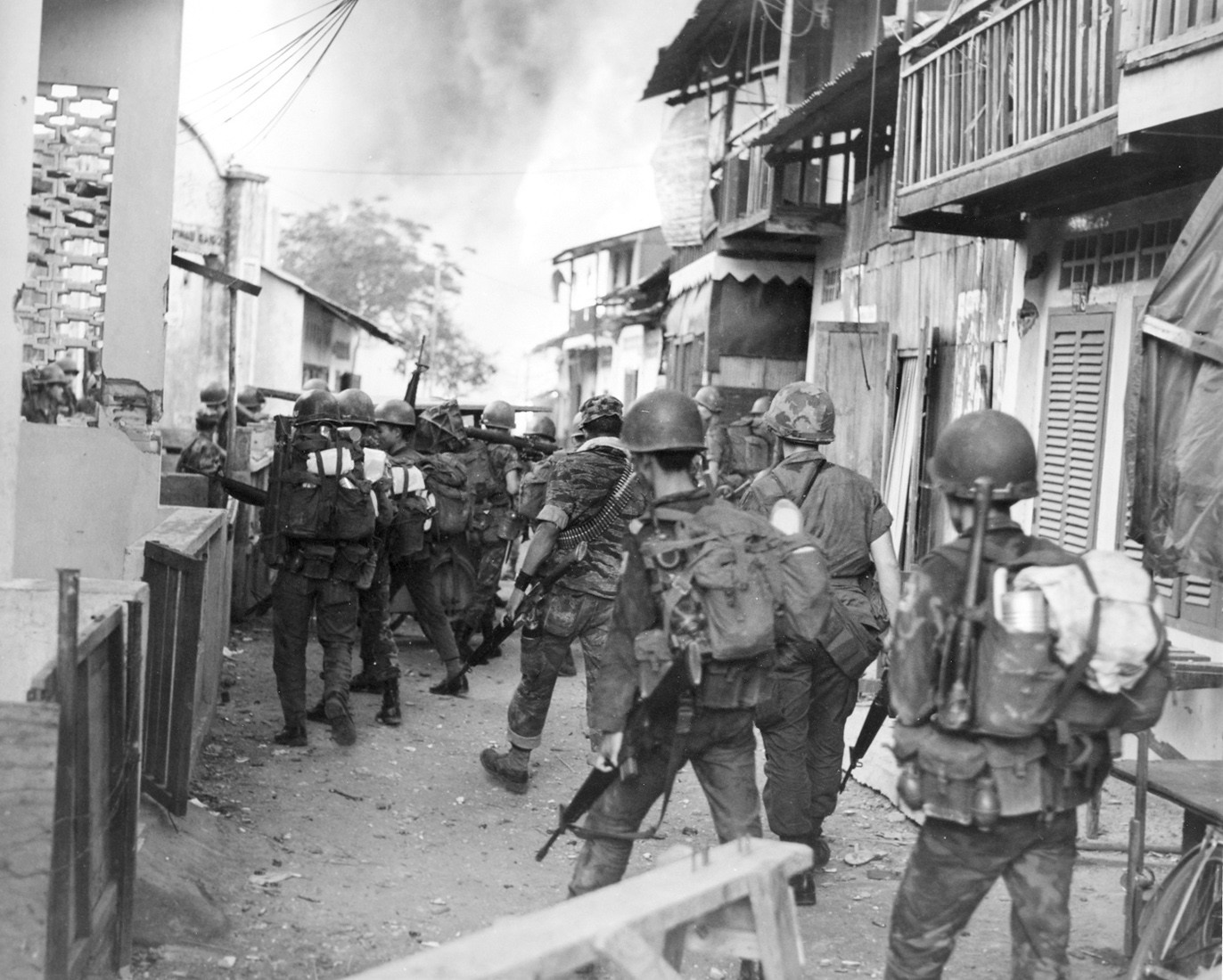 Members of the 7th Bn., ARVN Airborne Div., leave the flaming village of Tan Son Nhut after conducting a sweep - Photo by Donald Jellema Collection