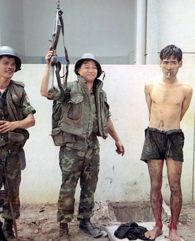South Vietnamese soldiers show off a Viet Cong prisoner captured near Tan Son Nhut Airbase. May 6, 1968