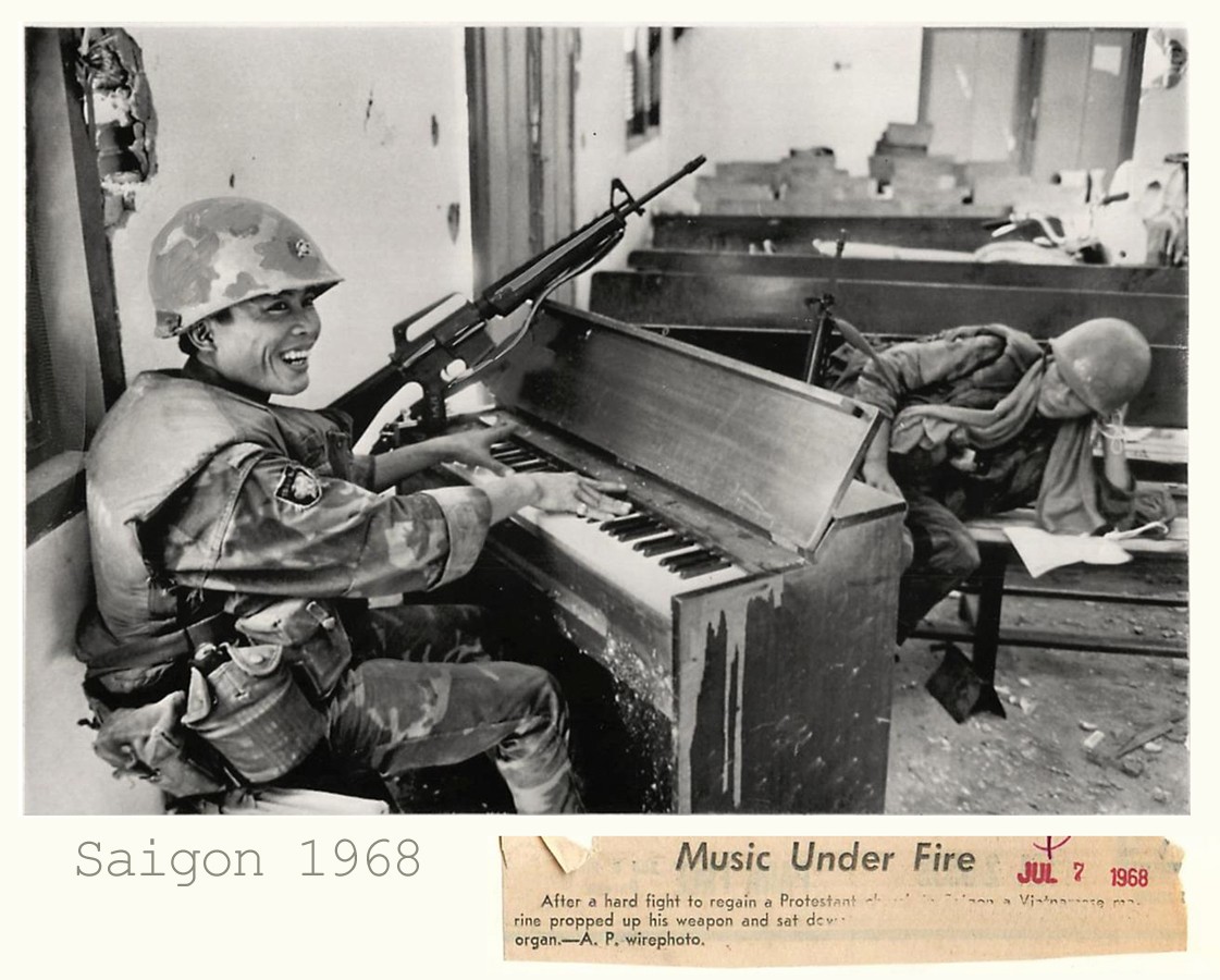 1968 - Vietnamese Marine plays shrapnel-marked pump organ amid ruins of Protestant church in Saigon