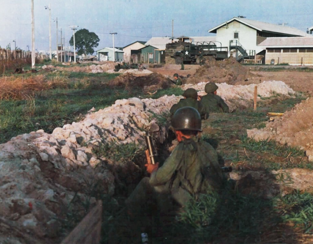 Vietnamese troops fire into enemy positions in the old French Cemetery from trenches dug along the southwestern perimeter of TSN Air Base 7 May 1968.source: fold3.com