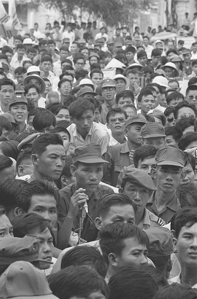 1967 - Vietnamese crowd attending political rally in My Tho. Many soldiers are in crowd