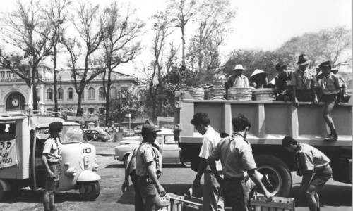 VN Boy Scouts along with other youth groups and civilian volunteers load supplies furnished by the government for distribution - Pike Photograph Collection