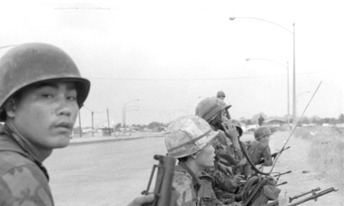 A squad of South Vietnamese soldiers of Co C, 30th ranger Bn, are on the alert for Viet Cong snipers just across Newport Bridge Mini-Tet - Douglas Pike Collection - Vietnam Center and Archive