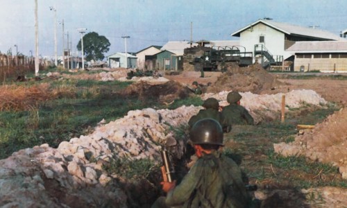 Vietnamese troops fire into enemy positions in the old French Cemetery from trenches dug along the southwestern perimeter of TSN Air Base 7 May 1968.source: fold3.com